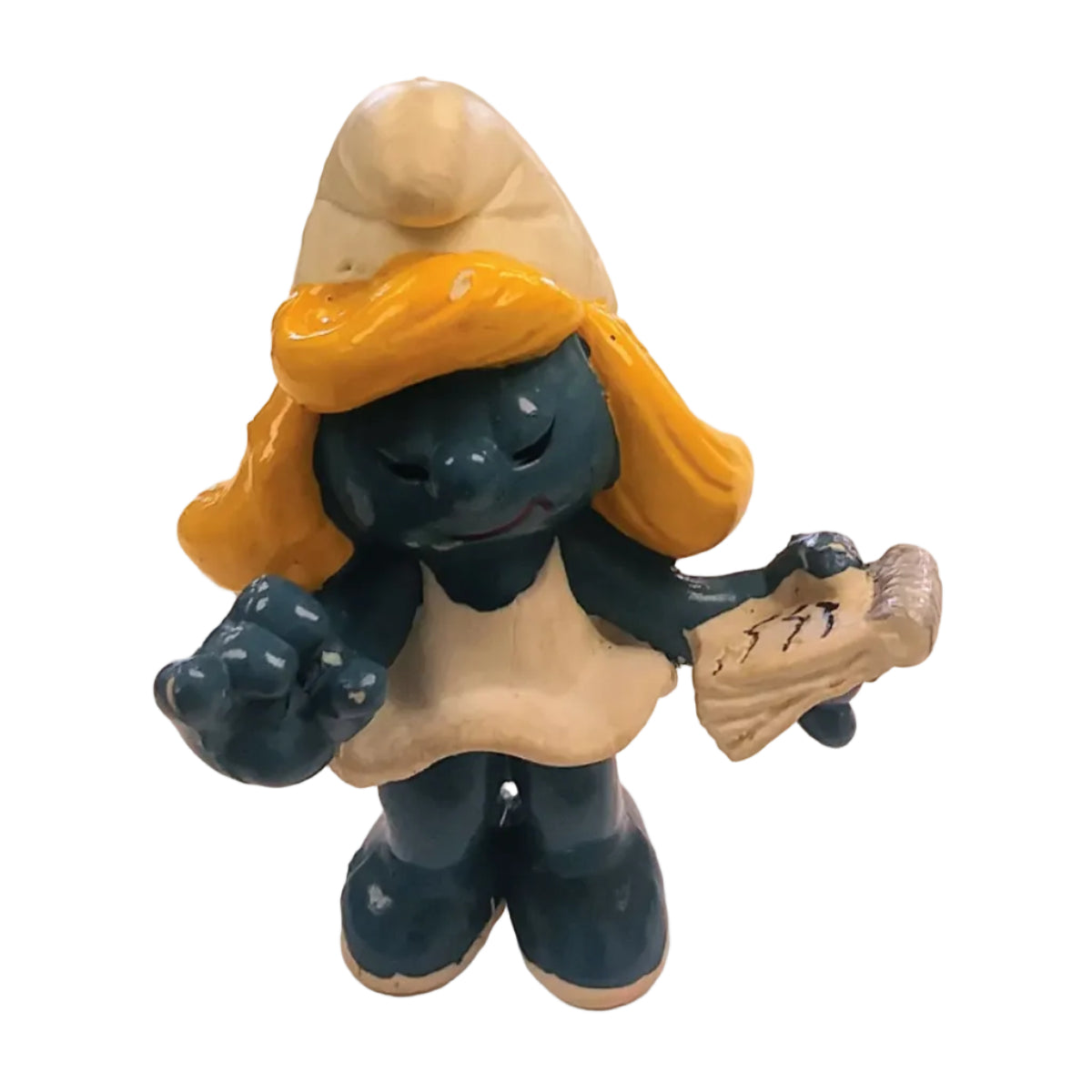 Smurf figurine with yellow hat and white dress holding a notepad on a white background