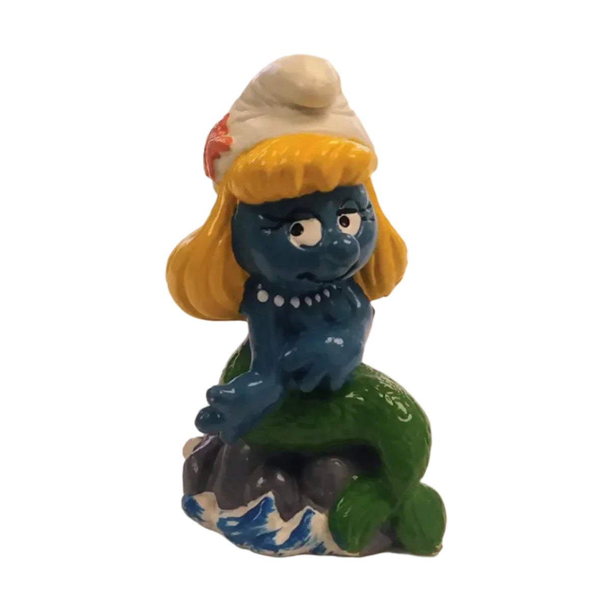 Mermaid Smurfette figurine with yellow hair and white hat on a white background